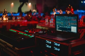 Black Laptop Beside Audio Mixer Set-depicting green tech